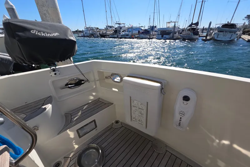 Cockpit of 2000 McKinna 48 Pilothouse yacht with marina view and sunny weather.
