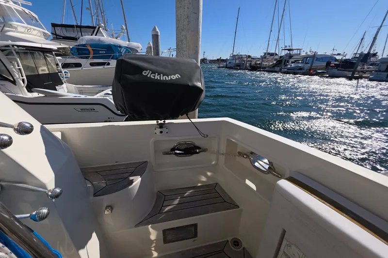 2000 McKinna 48 Pilothouse yacht docked, featuring a Dickinson grill and scenic marina view.