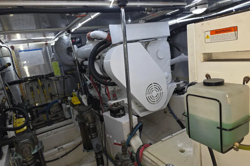 Engine room of 2000 McKinna 48 Pilothouse yacht, showcasing mechanical components and systems.
