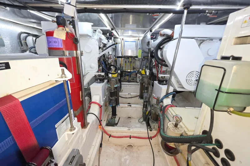 Engine room of 2000 McKinna 48 Pilothouse yacht, showcasing mechanical components and systems.