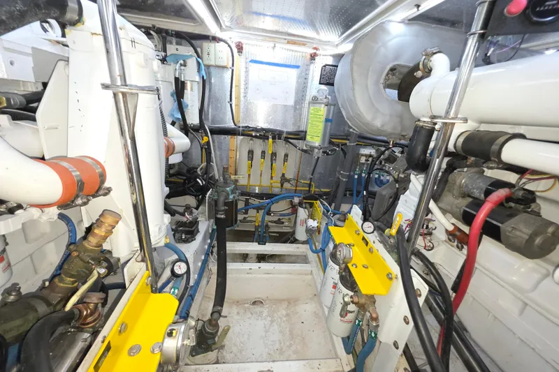 Engine room of 2000 McKinna 48 Pilothouse yacht, showcasing mechanical components and systems.
