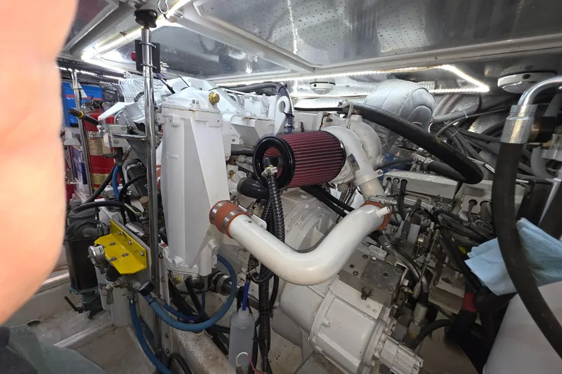 Engine room of a 2000 McKinna 48 Pilothouse yacht, showcasing mechanical components.
