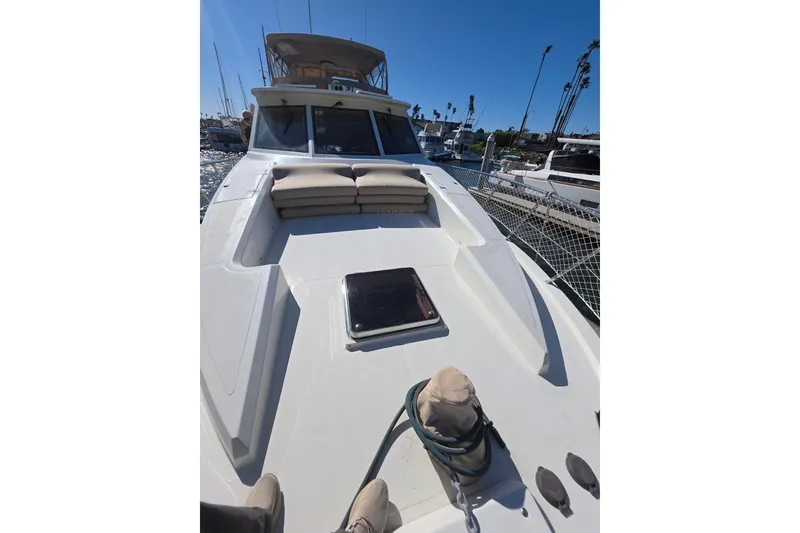 2000 McKinna 48 Pilothouse yacht deck with seating, docked in a marina.