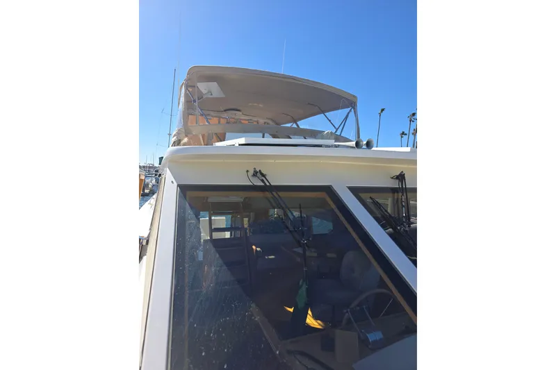 2000 McKinna 48 Pilothouse yacht with flybridge under clear blue sky.
