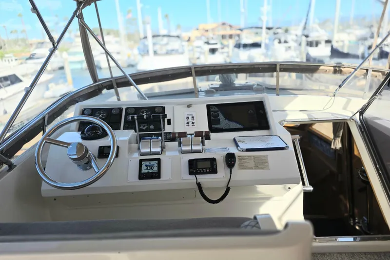 Pilothouse of 2000 McKinna 48 yacht with steering wheel and navigation equipment.