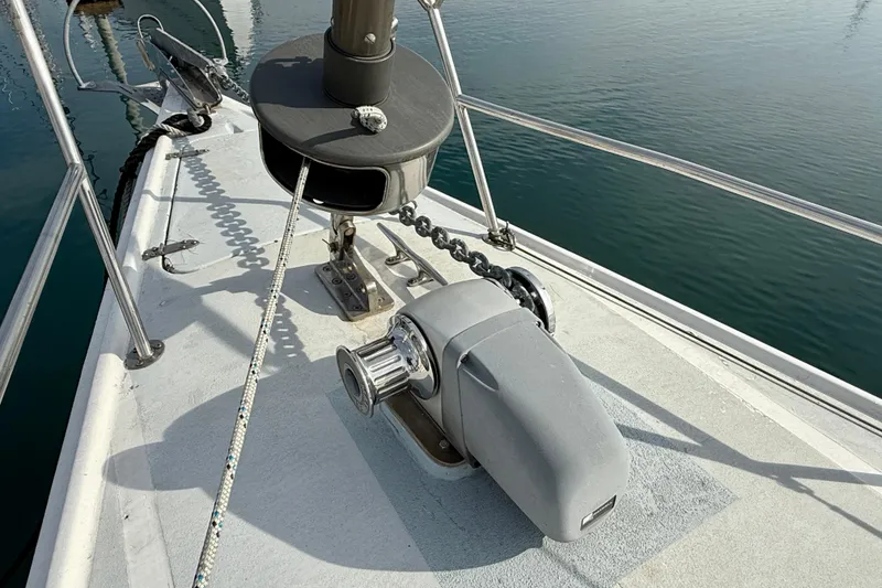 Bow of 1985 MacGregor 65 sailboat with anchor chain and winch system.