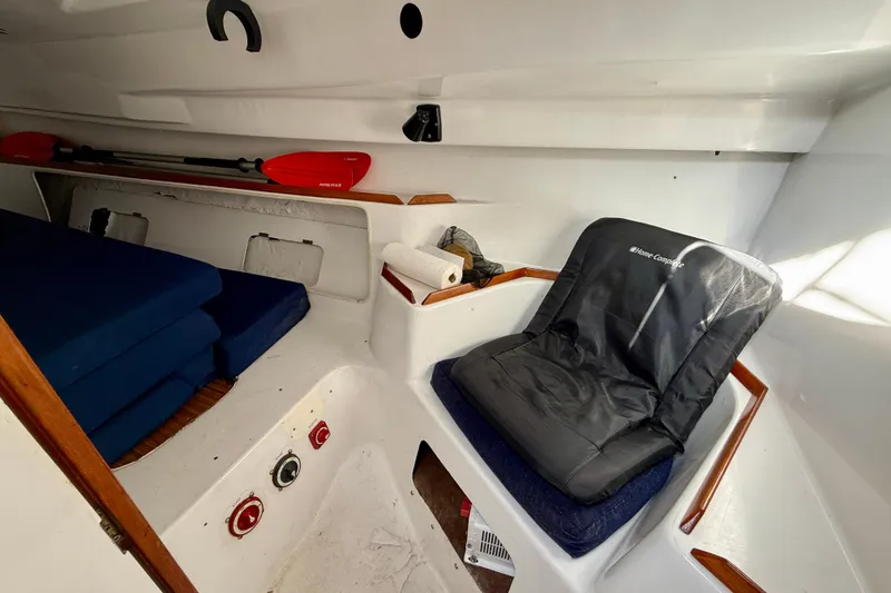 Interior of a 1985 MacGregor 65 sailboat with seating and storage.