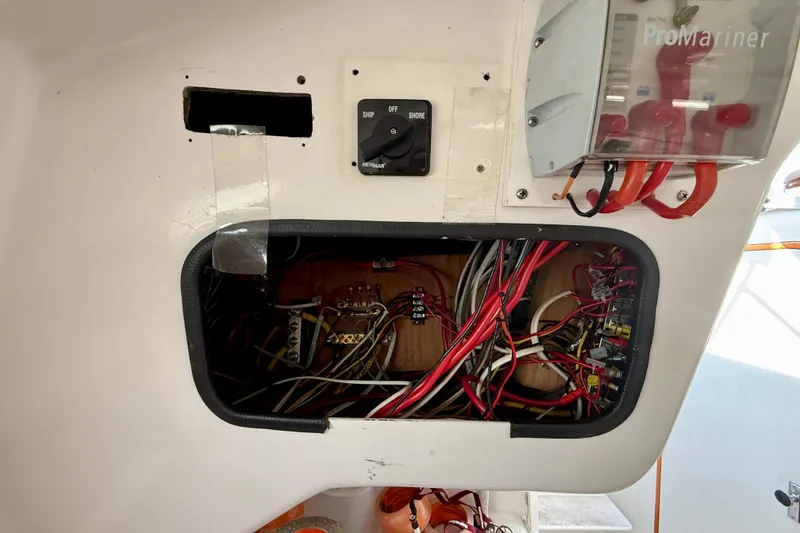 Electrical panel of a 1985 MacGregor 65 sailboat, featuring wiring and switches.