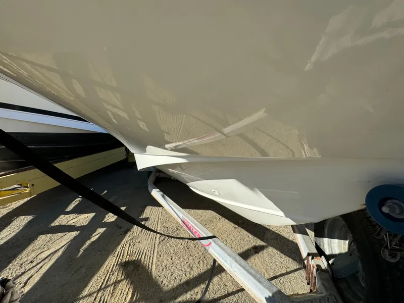 2016 Boston Whaler 170 MONTUCK boat on trailer, close-up view of hull and wheel.