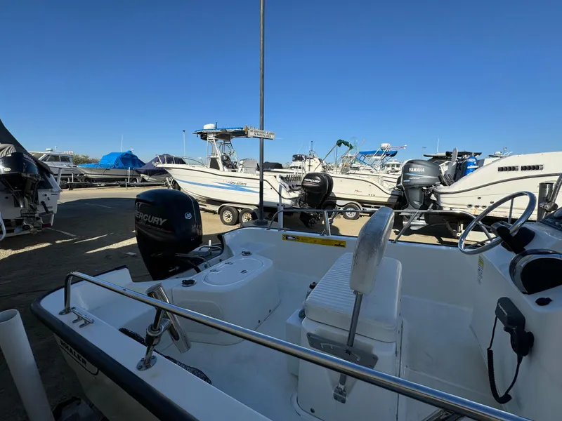 2016 Boston Whaler 170 MONTUCK boat in marina, surrounded by other boats.