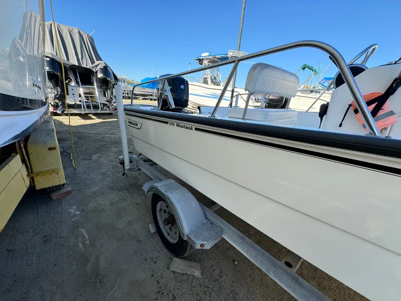 2016 Boston Whaler 170 MONTUCK boat on trailer, parked outdoors.