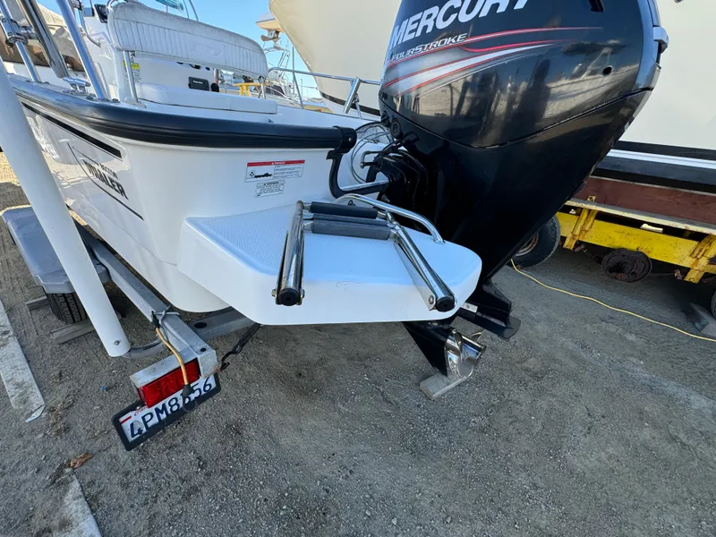 2016 Boston Whaler 170 MONTUCK boat with Mercury engine, parked on a trailer.