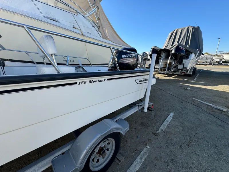 2016 Boston Whaler 170 Montauk boat on trailer, parked outdoors.