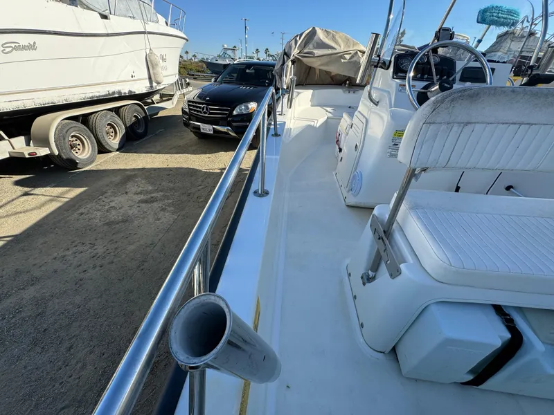 2016 Boston Whaler 170 MONTUCK boat docked, featuring seating and steering wheel.