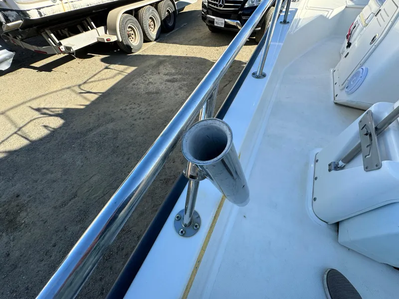 2016 Boston Whaler 170 MONTUCK boat deck with rod holder and railing.
