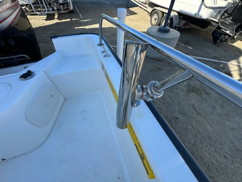2016 Boston Whaler 170 MONTUCK boat interior with stainless steel railing and rod holder.
