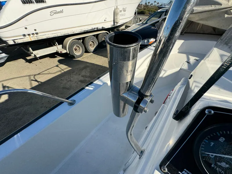 2016 Boston Whaler 170 MONTUCK boat interior with rod holder and dashboard view.