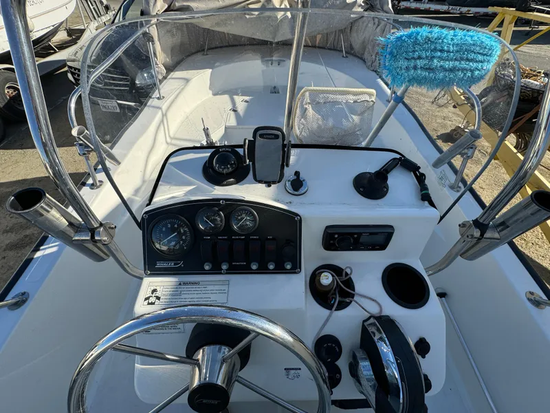 2016 Boston Whaler 170 MONTUCK boat dashboard with steering wheel and controls.