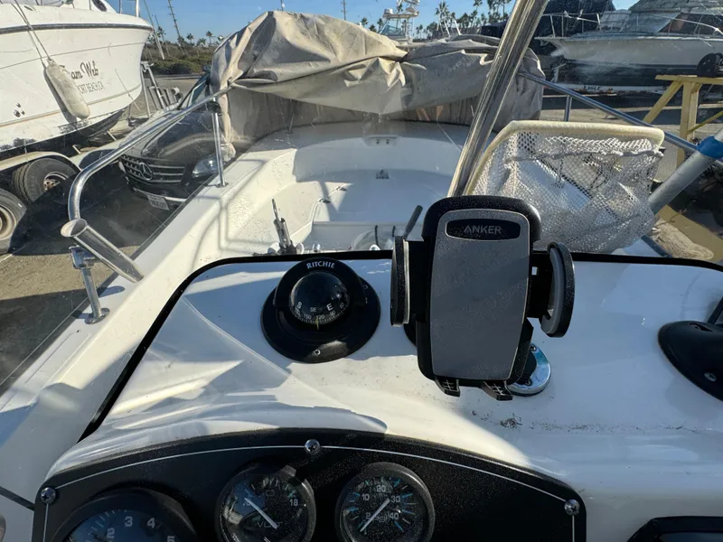 2016 Boston Whaler 170 MONTUCK boat dashboard with compass and phone holder.