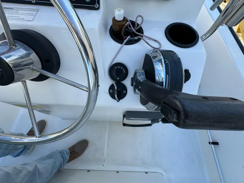 Steering console of 2016 Boston Whaler 170 MONTUCK boat with throttle and controls.