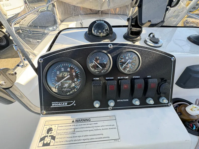 Control panel of a 2016 Boston Whaler 170 MONTUCK boat with gauges and switches.