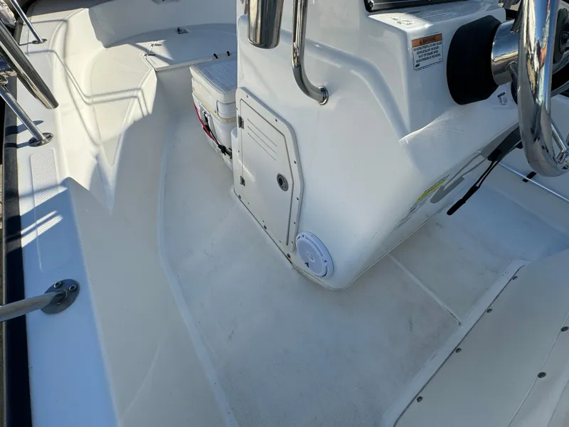 2016 Boston Whaler 170 MONTUCK boat interior with steering console and seating area.