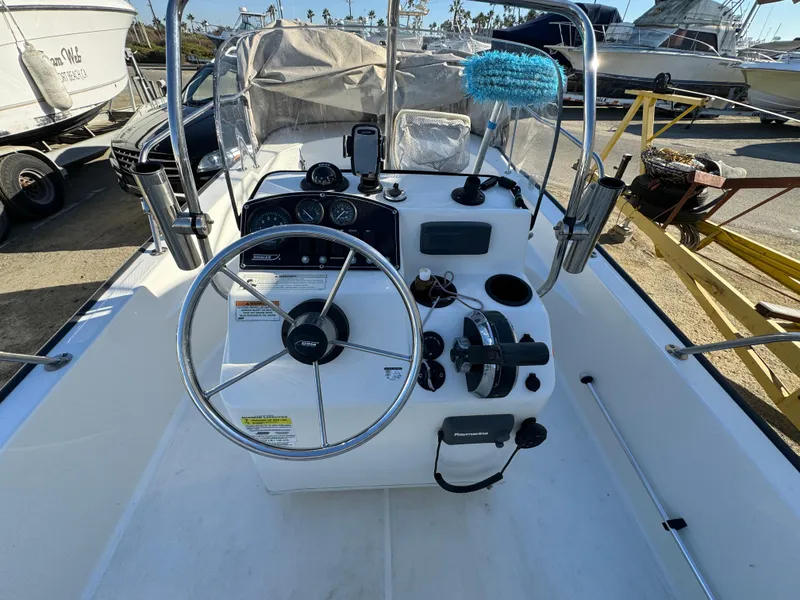 2016 Boston Whaler 170 MONTUCK boat dashboard with steering wheel and controls.