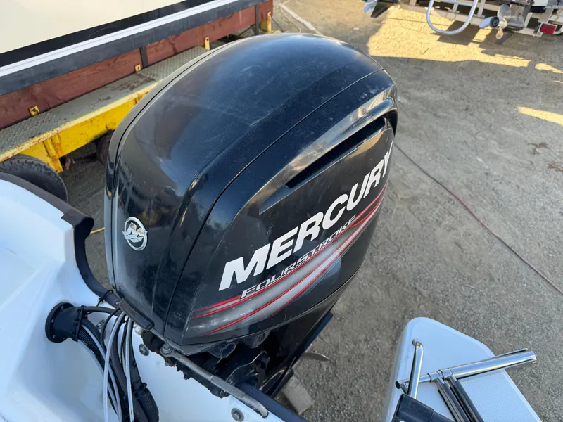 Boston Whaler 170 MONTUCK 2016 with Mercury outboard motor in a boatyard.
