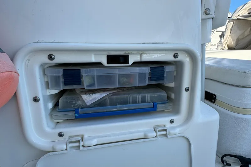Storage compartment on a 2016 Boston Whaler 170 MONTUCK boat with tackle boxes.