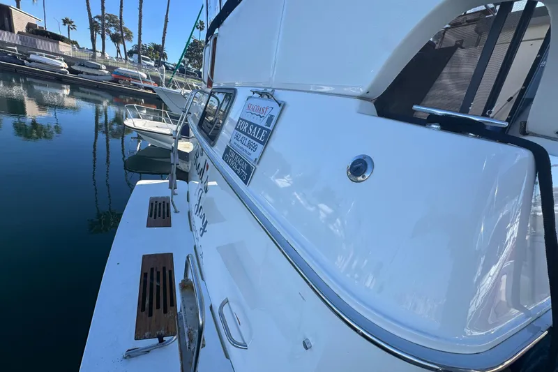 1990 Sea Ray 380 Aft Cabin yacht for sale, docked in marina.