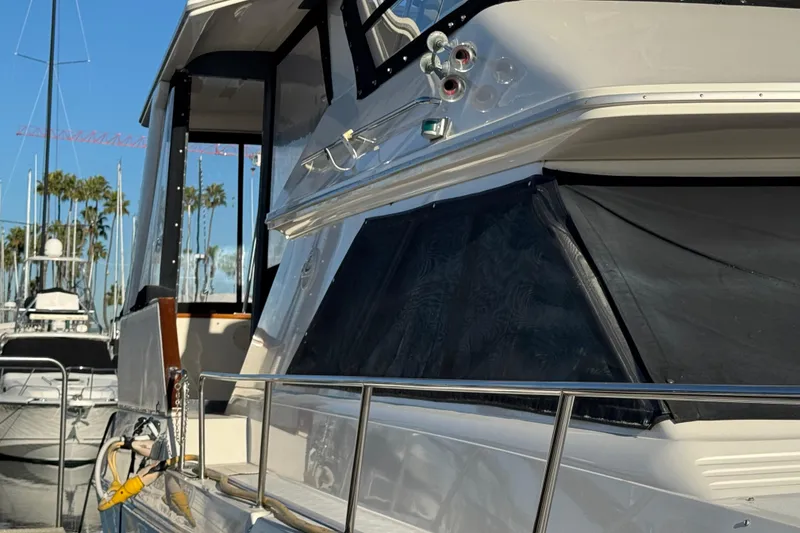 1990 Sea Ray 380 Aft Cabin yacht docked at marina, side view.