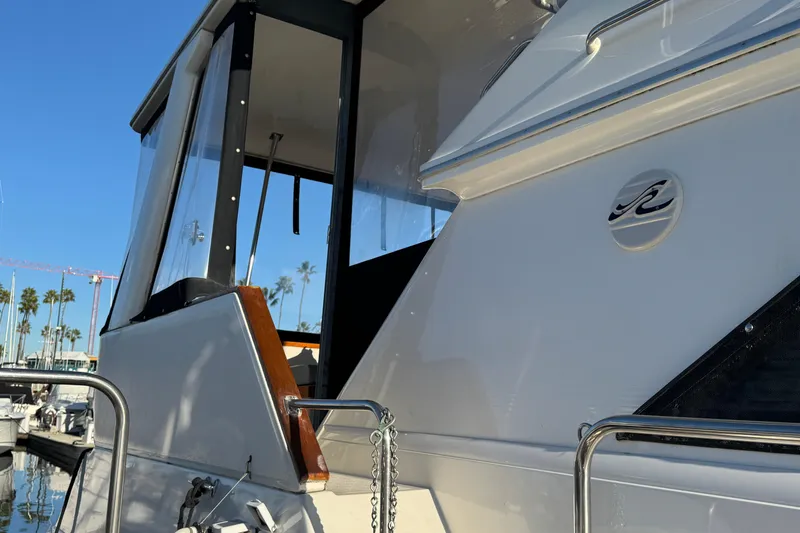 1990 Sea Ray 380 Aft Cabin yacht docked, showcasing sleek design and logo.