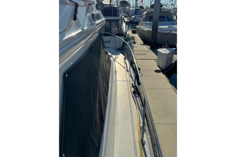 1990 Sea Ray 380 Aft Cabin yacht docked at marina, side view.