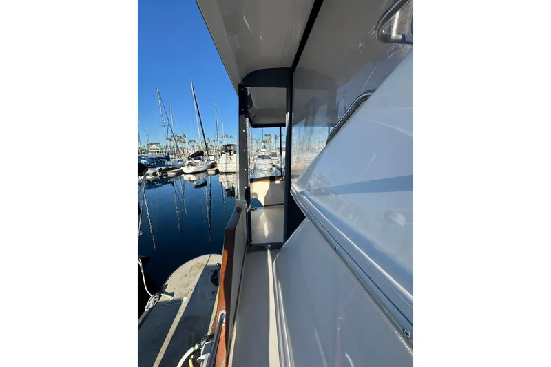 1990 Sea Ray 380 Aft Cabin yacht docked at marina, clear blue sky.