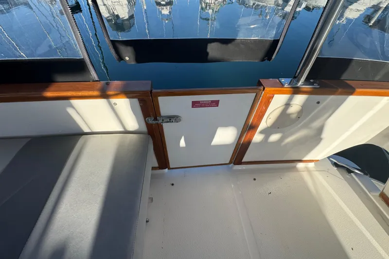 1990 Sea Ray 380 Aft Cabin boat interior with seating and wooden accents.