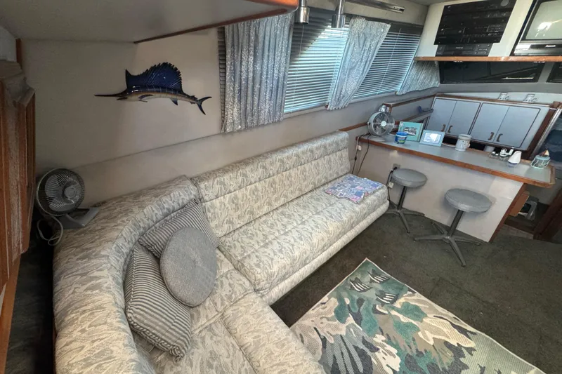 Interior of 1990 Sea Ray 380 Aft Cabin with cozy seating and nautical decor.