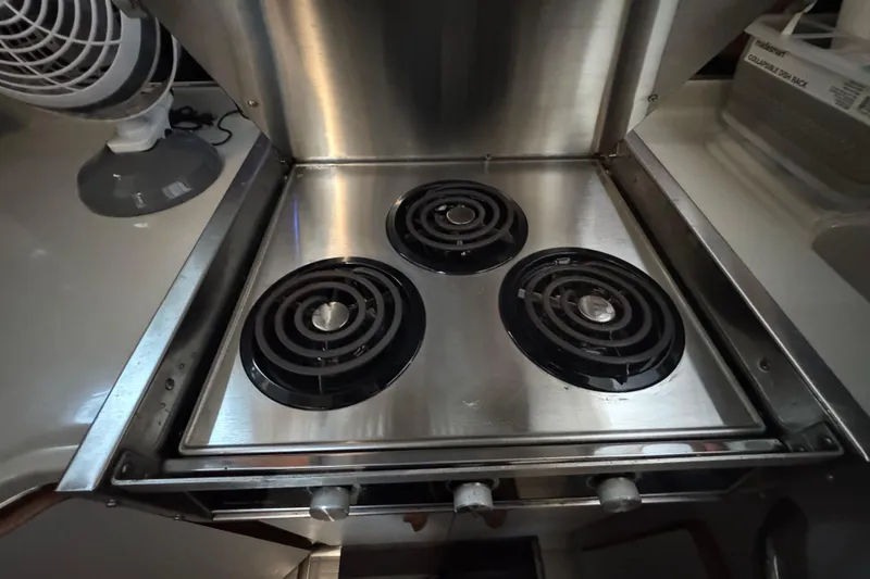 Stainless steel stove with three burners on 1990 Sea Ray 380 Aft Cabin yacht.