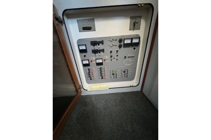 Electrical control panel inside 1990 Sea Ray 380 Aft Cabin boat, featuring gauges and switches.