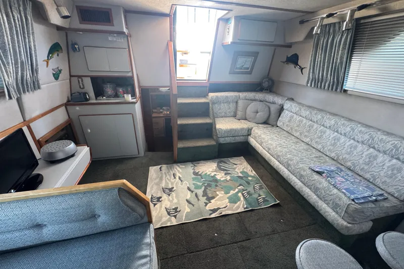 Interior of 1990 Sea Ray 380 Aft Cabin with cozy seating and nautical decor.