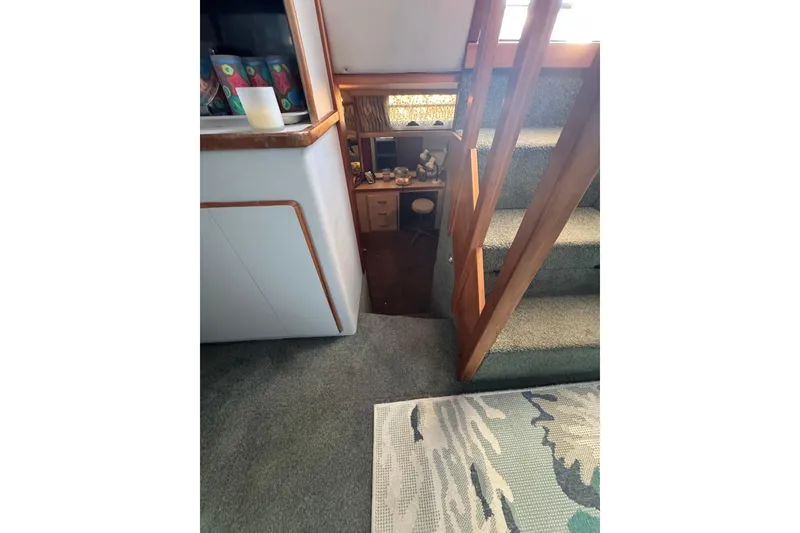 Interior of 1990 Sea Ray 380 Aft Cabin with stairs and cozy decor.
