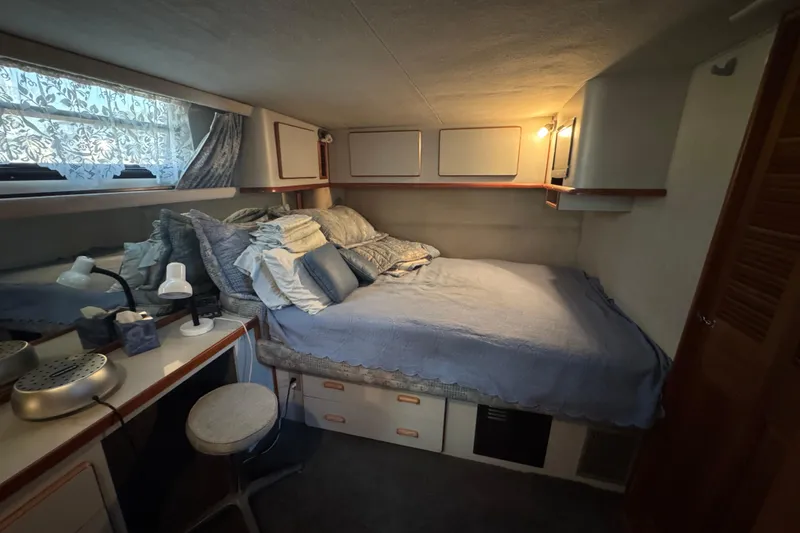 Interior of 1990 Sea Ray 380 Aft Cabin, cozy bedroom setting.