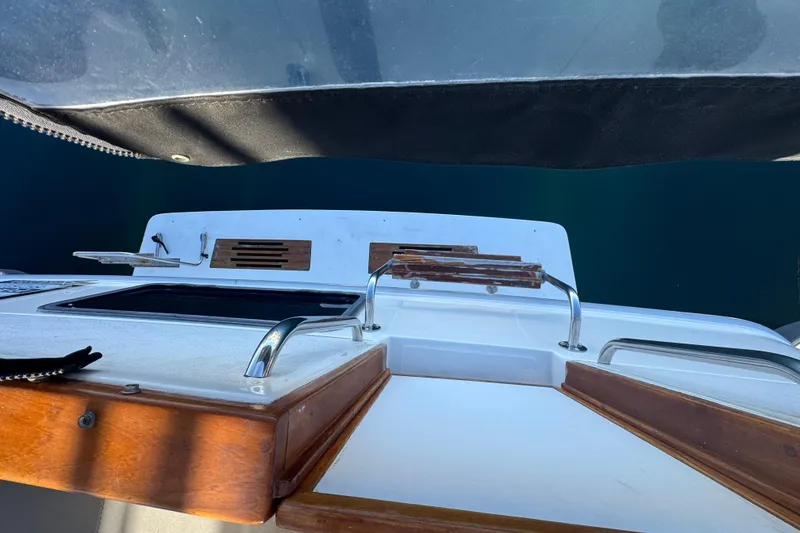 1990 Sea Ray 380 Aft Cabin boat deck with wooden accents and chrome railings.