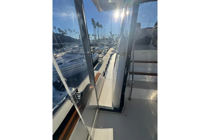 1990 Sea Ray 380 Aft Cabin yacht docked in sunny marina with palm trees.