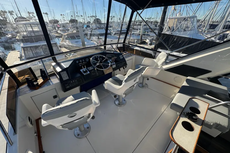 Cockpit of 1990 Sea Ray 380 Aft Cabin yacht with marina view.