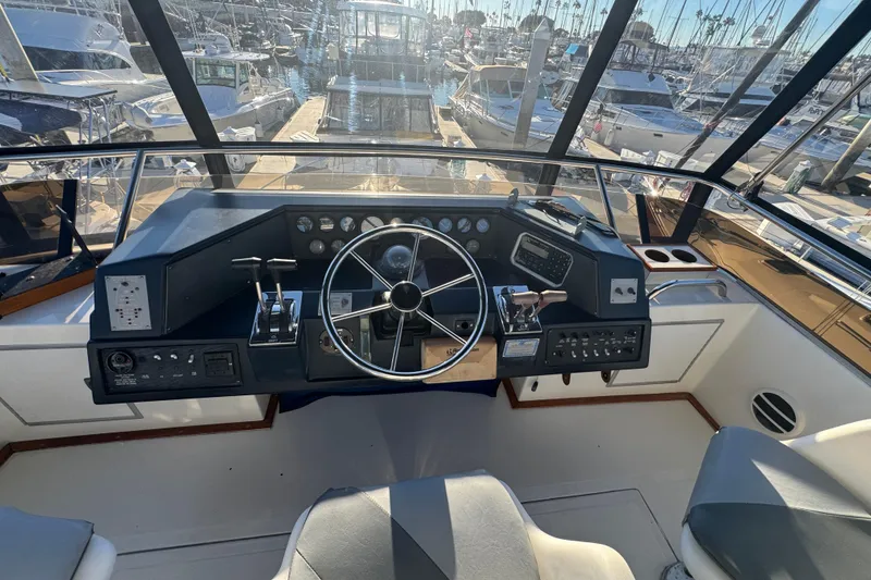 Cockpit of 1990 Sea Ray 380 Aft Cabin yacht with steering wheel and controls.