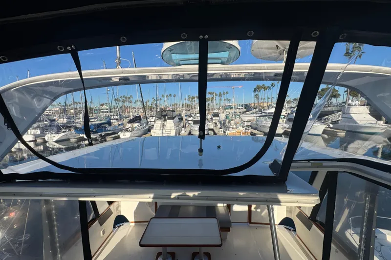 1990 Sea Ray 380 Aft Cabin yacht interior view at marina with boats and palm trees.