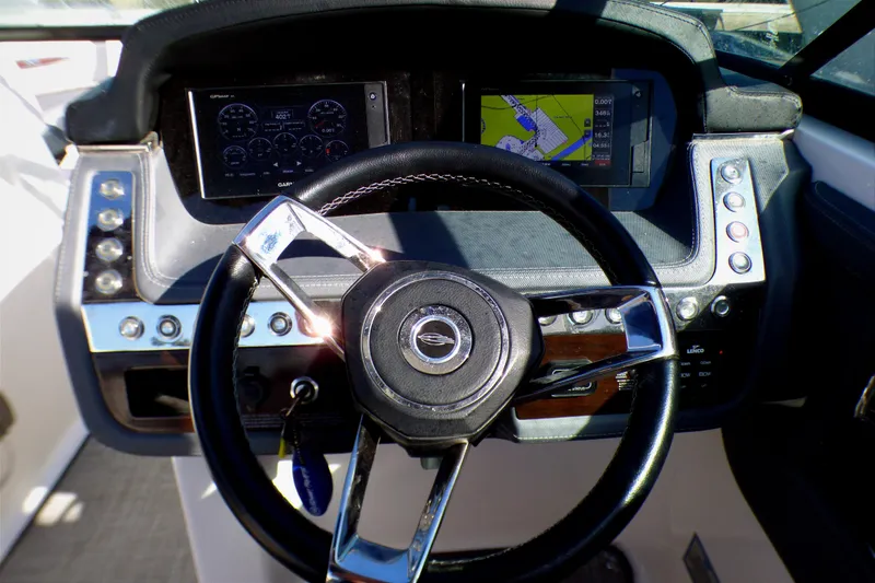 2018 Chaparral 267 SSX boat dashboard with steering wheel and navigation displays.