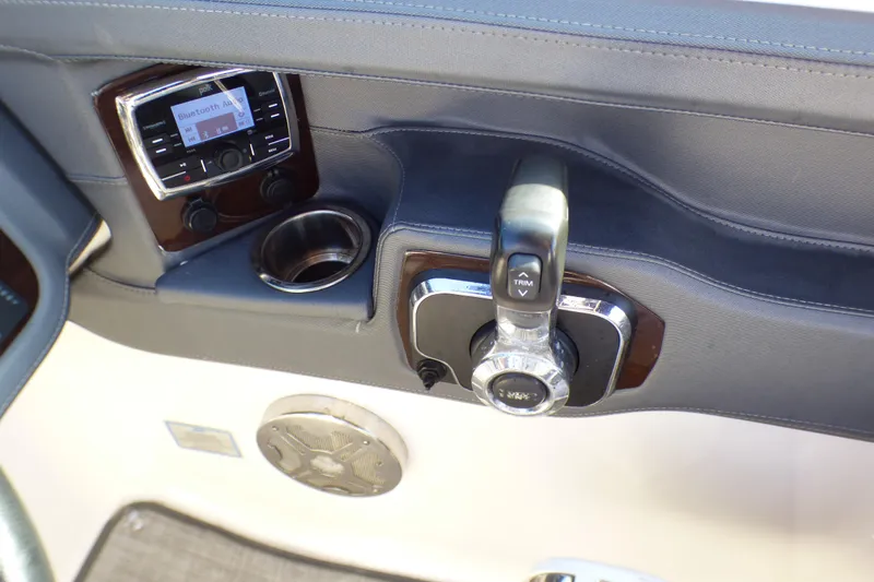 2018 Chaparral 267 SSX boat dashboard with control panel and cup holder.