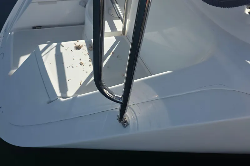 Close-up of 1994 Hunter Legend 35.5 yacht deck with railing and scattered debris.