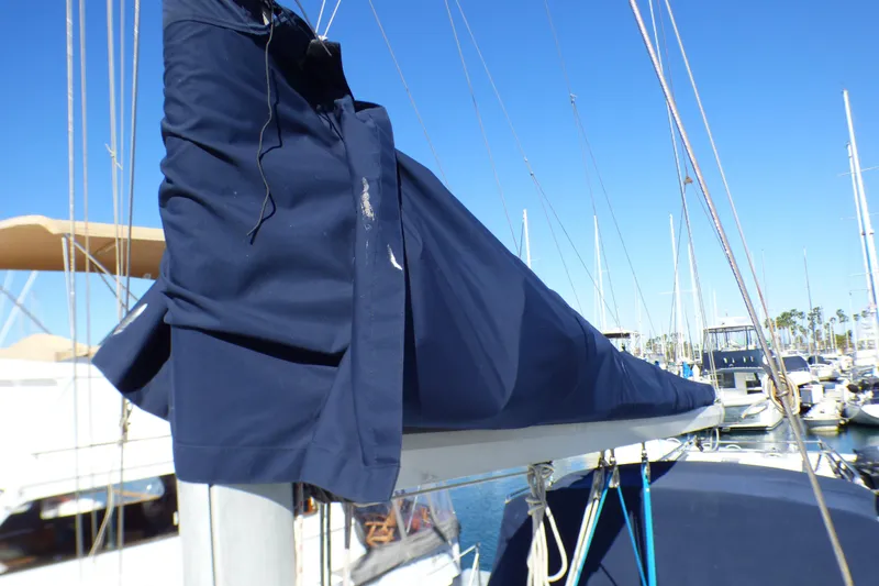 1994 Hunter Legend 35.5 sailboat with blue sail cover in marina.